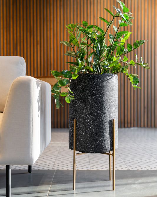 Buy Black Sleek Planter with metal stand for living room. Buy black colour flower pots for your home or office spaces. This modern planter works well indoors. This tall round planter can be kept in any home corner. Free shipping pan India.