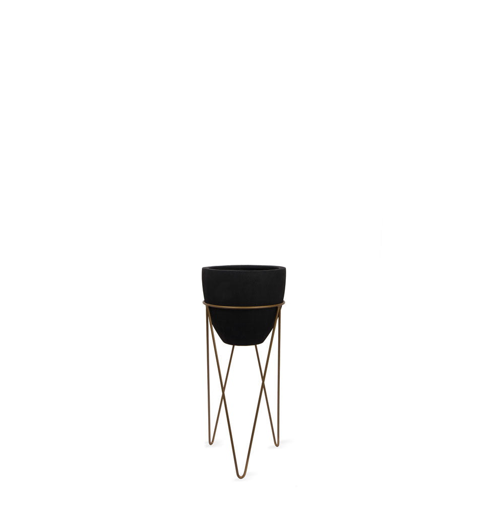 This fiberglass black planter with gold stand designed by Studio Palasa is an ideal fit for your indoor spaces like your entryway or any corner of your home or office space. Combined with the stand, the planter adds a dramatic effect onto your plants. 