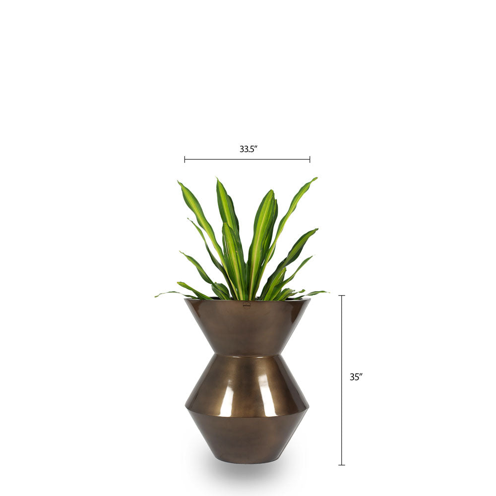 This Brass Metallic finished FRP Planter is a perfect example of contemporary design. Its unique funnel shape adds an eye-catching style to any space. Perfect for both indoor and outdoor settings, the Funnel Planter works well with a range of plants, such as Bamboo Palm, Dracaena Dara Singh, or Dracaena Draco.