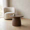 Single brown Teddy Stone Table with a cup in a neutral sitting nook.