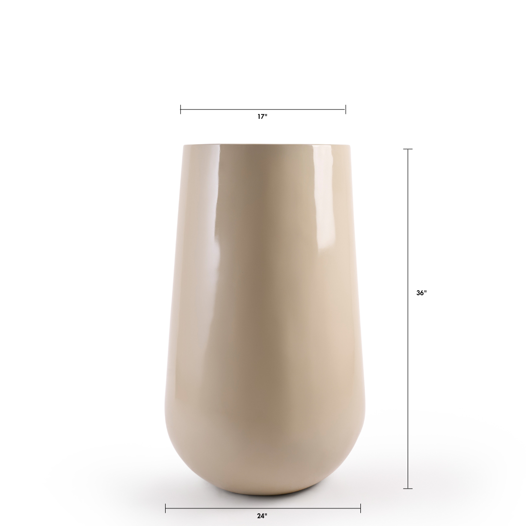 The Beige Rony FRP large planter by Studio Palasa is an ideal fit for classic and contemporary residences, balcony's and gardens. This beige large round indoor planter pot has been designed to be tall and sleek with a glossy finish, making it the perfect addition to your indoor homes.