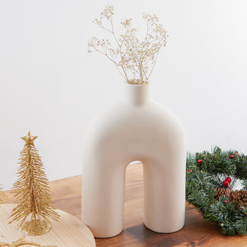 The Bridge Nordic White Ceramic Vase by Studio Palasa is a masterful addition to any room. Add  dried branches or keep them in its true ceramic form or style with our collection of other Nordic Vases to bring your space to life. 