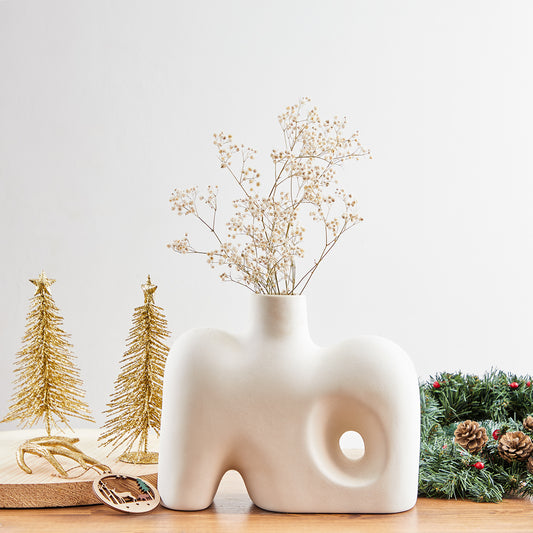 Crafted with a keen eye for Nordic design principles, our white Nordic vase embodies the essence of clean lines, sleek forms, and a pristine color palette. Its minimalist silhouette ensures that it seamlessly integrates into diverse decor styles, making it a perfect addition to modern, Scandinavian, or eclectic interiors.
