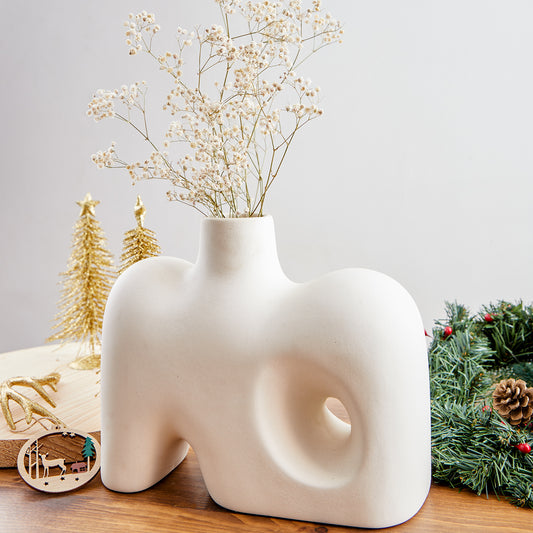 Crafted with a keen eye for Nordic design principles, our white Nordic vase embodies the essence of clean lines, sleek forms, and a pristine color palette. Its minimalist silhouette ensures that it seamlessly integrates into diverse decor styles, making it a perfect addition to modern, Scandinavian, or eclectic interiors.