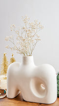 Crafted with a keen eye for Nordic design principles, our white Nordic vase embodies the essence of clean lines, sleek forms, and a pristine color palette. Its minimalist silhouette ensures that it seamlessly integrates into diverse decor styles, making it a perfect addition to modern, Scandinavian, or eclectic interiors.